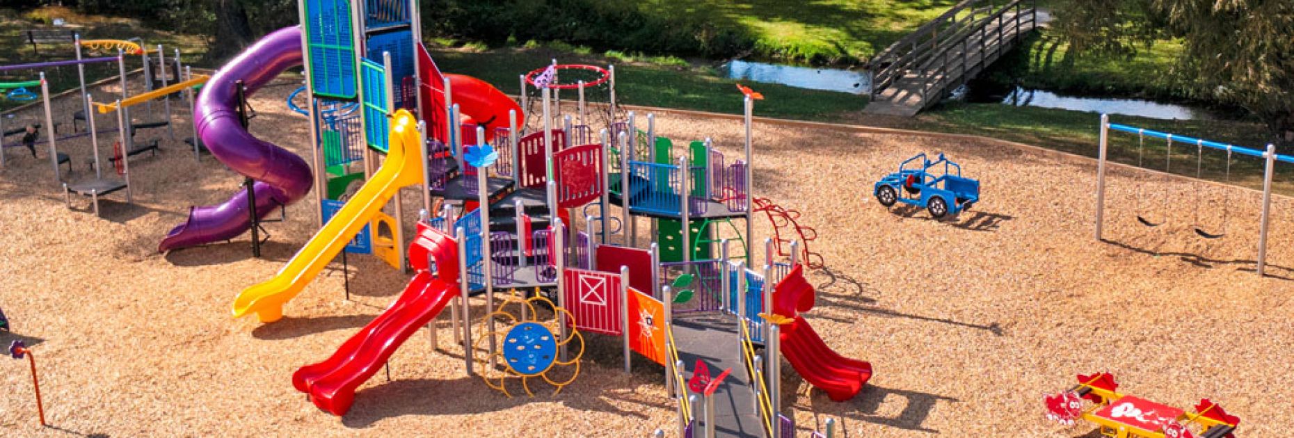aerial shot of commercial playground equipment ontario, featuring extensive wheelchair ramping and a tower structure