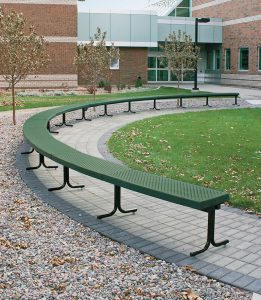 dark green, semi-circle-shaped outdoor bench, situated on concrete at a college in Alberta, Canada