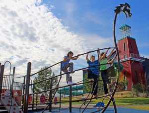 kids climbing on Viking Ship themed playground structure