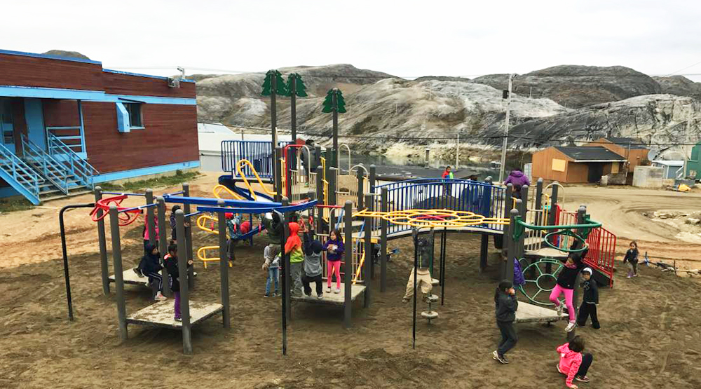kids playing on newly installed playground eqiupment arctic canada