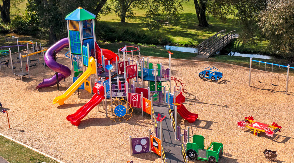 aerial shot of commercial playground equipment ontario, featuring extensive wheelchair ramping and a tower structure