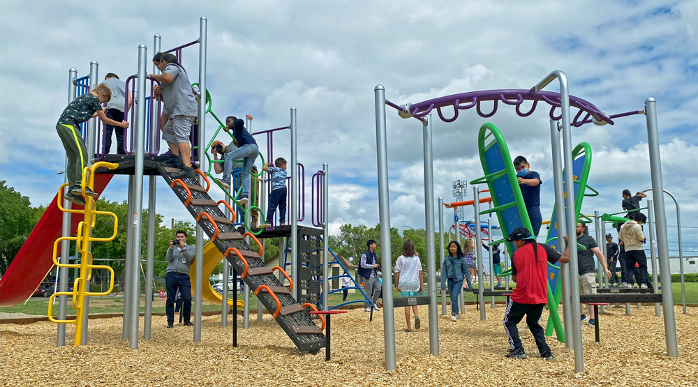 kids playing on commercial playground equipment Saskatchewan