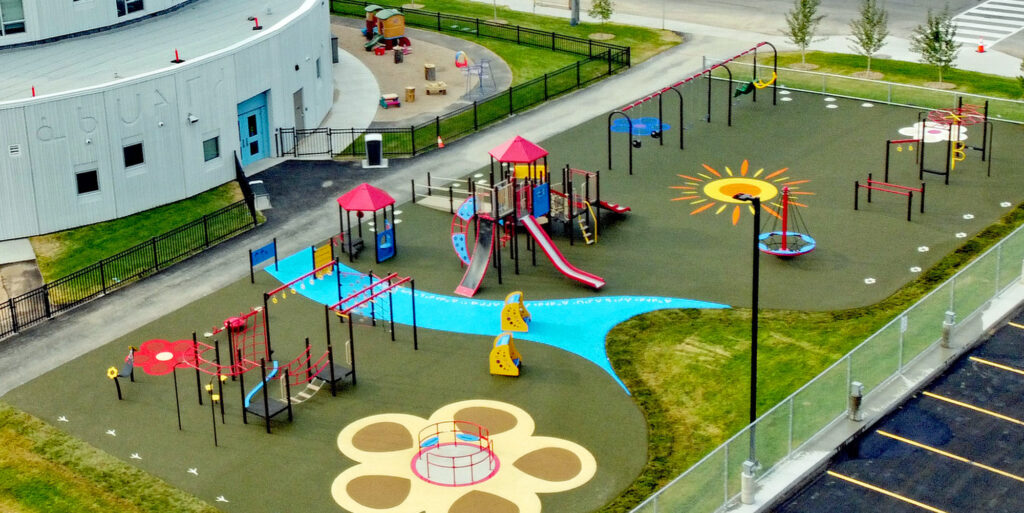 Aerial view of a well-maintained school playground with swings