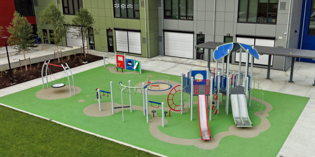 Large playground with a mix of slides, swings, and safety surfacing